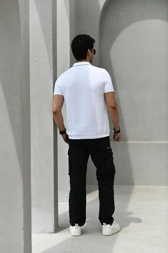 Folded Posh Monk white polo on warm cream surface styled editorial style