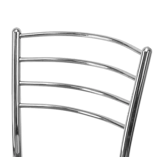 The Goyal chair placed next to a wooden dining table in a modern home setting showing its scale and proportions.