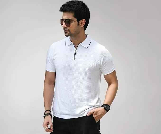 Premium flat-lay of the white Posh Monk polo with accessories on warm cream surface
