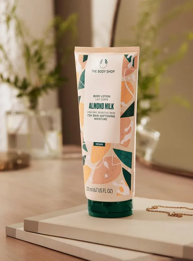 Soft glowing skin close-up showing smooth hydrated texture after using the lotion, dewy and luminous in warm honey-toned light, sensitive skin visibly calm and nourished